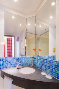 a bathroom with a sink and a mirror at Exe City Park Hotel in Prague