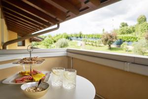 a table with a plate of food and glasses at Dream's hill in San Pietro di Feletto