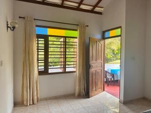 a room with a door and a room with a table at Chamila's place in Nikawatawana