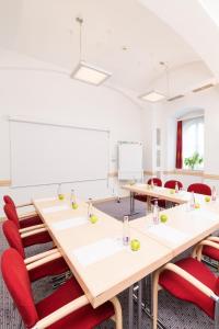 a conference room with a long table and red chairs at Exe City Park Hotel in Prague