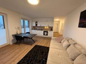 a living room with a couch and a table at Maritime Suite an der Geeste in Bremerhaven