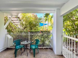 a balcony with a table and chairs and a fence at Tropical Mango House Stay in Airlie Beach +27 photos