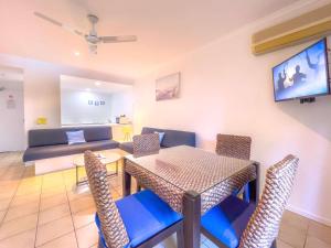 a living room with a table and chairs and a couch at Tropical Mango House Stay in Airlie Beach