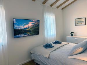 a bedroom with a bed with two blue towels on it at Casa Rinata in Novigrad Istria +39 photos