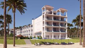 a large white building with palm trees in front of it at The Grand Resort Rarotonga - Adults Only in Rarotonga