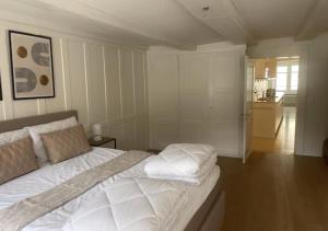 a bedroom with a bed with white sheets and pillows at The R Apartment Bodensee - Old Town in Schaffhausen
