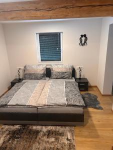 a bedroom with a large bed and a window at MyAlpenloft 1 in Deutschgriffen