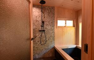 a bathroom with a shower with a tub in it at Koya Miyama in Nantan city