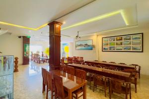 a dining room with wooden tables and chairs at Kim Ngoc Khanh Hotel in Tuy Hoa