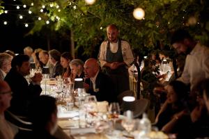 a group of people sitting around a table at a party at Corte Massimago in Mezzane di Sotto