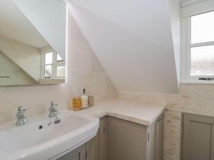 a bathroom with a sink and a mirror at Greenham Rise in Chiselborough +16 photos