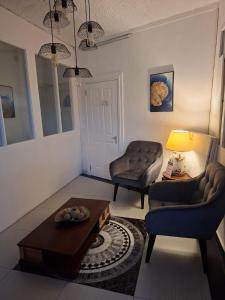 a living room with a couch and a table at Hello Tourist Residence in Quatre Bornes