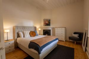 a bedroom with a bed with a cat sitting on it at Thedell Cottage - A Boutique Heritage Escape in Auburn