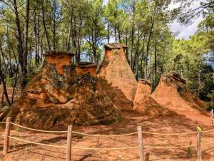 a group of large rocks in a forest at Les Tournillayres in Bédoin