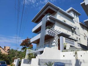 a white building with stairs on the side of it at Villa Vana By DanCenter | 5BHK | Pvt Pool | Baga Beach, GOA in Arpora