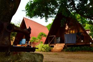 a house with a red roof and a building at Thats why beach hotel in Trincomalee