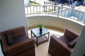 a balcony with two chairs and a table and a railing at NO 95 SUITES VI in Lagos