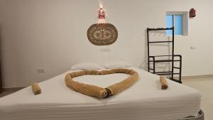 a bed with a heart made out of a blanket at Three Elements Mirissa in Mirissa