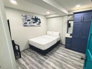 a small bedroom with a bed and a mirror at Tobago Tropical Hideaway in Lowlands