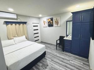 a bedroom with a bed and a dresser and a mirror at Tobago Tropical Hideaway in Lowlands