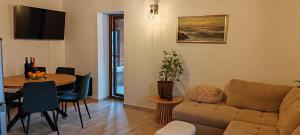 a living room with a couch and a table at CaSa ViTo Kumrovec in Brezje