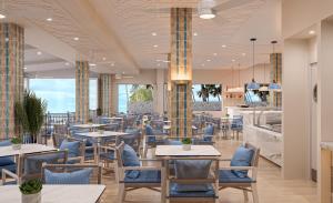 a restaurant with tables and chairs and a cafeteria at The Grand Resort Rarotonga - Adults Only in Rarotonga