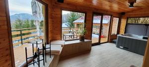 a room with a balcony with a kitchen and a tub at CaSa ViTo Kumrovec in Brezje