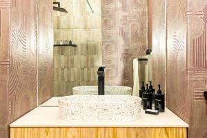 a bathroom with a counter with two sinks and a mirror at Table Mountain Views - Stylish Gardens Apartment in Cape Town +21 photos