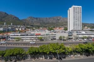 a view of a city with mountains in the background at Table Mountain Views - Stylish Gardens Apartment in Cape Town