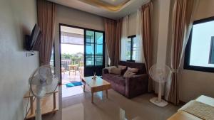 a living room with a couch and a table at Samati Hill - Sunset Pool Villa 7 - Klong Ning Beach in Ko Lanta Yai