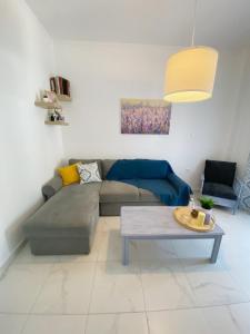 a living room with a couch and a table at Sadin apartment in Neos Marmaras