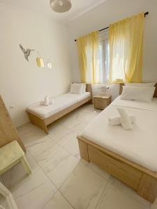 a bedroom with two beds and a window at Sadin apartment in Neos Marmaras