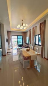 a dining room with a table and a living room at Samati Hill - Sunset Pool Villa 7 - Klong Ning Beach in Ko Lanta Yai