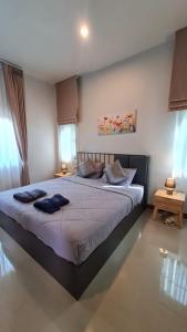 a bedroom with a large bed with two pillows on it at Samati Hill - Sunset Pool Villa 7 - Klong Ning Beach in Ko Lanta Yai +51 photos