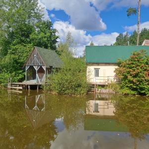 a house on a body of water at Калина in Deneshi