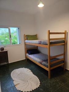 a room with two bunk beds and a rug at Refúgio da Zena in Mairiporã