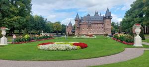 un castello con un giardino di fiori davanti di Boerderij Hazenveld a Kockengen