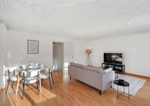 a living room with a couch and a table at The R Apartment Hemmental in Schaffhausen +27 photos