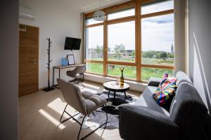 a living room with a couch and a table at Strommer wine das Gästehaus in Purbach am Neusiedlersee