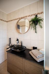 a bathroom with a black sink and a mirror at Strommer wine das Gästehaus in Purbach am Neusiedlersee +39 photos