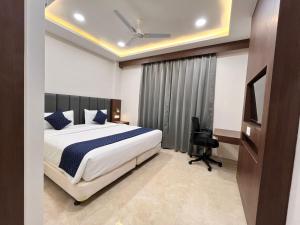 a bedroom with a bed and a desk and a chair at Nyotel-MP Nagar Bhopal in Bhopal