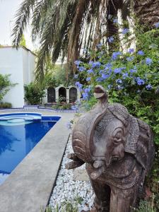 a statue of an elephant next to a swimming pool at Séjour Royal in Xàtiva