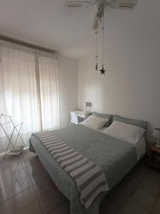 a bedroom with a bed with a striped blanket at Su Planu in Cagliari