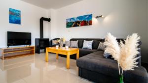 a living room with a couch and a table at Villa Cyprian by Villas Guide in Kampor
