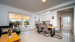 a kitchen and living room with a table and chairs at Villa Cyprian by Villas Guide in Kampor
