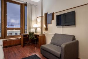 a hotel room with a chair and a television at Scandic Polar in Rovaniemi