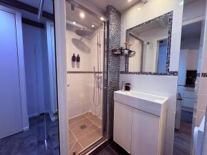 a bathroom with a shower and a sink and a mirror at Studio, terrasse & cathédrale in Valence +12 photos