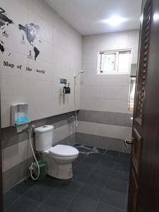 a bathroom with a toilet and a map of the world on the wall at House of love in Xiaoliuqiu +39 photos