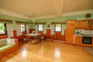 a kitchen with wooden cabinets and a table in a room at Winzerhaus am Eichberg in Leutschach