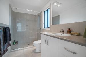a bathroom with a sink and a toilet and a shower at Long Island Retreat - Rosella in Murray Bridge +36 photos
